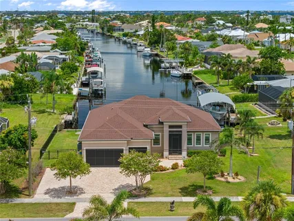 an aerial view of house with yard and lake view