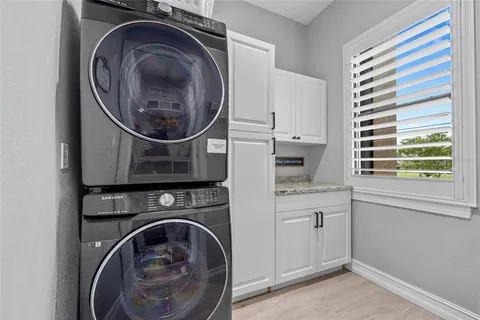 a utility room with sink dryer and washer