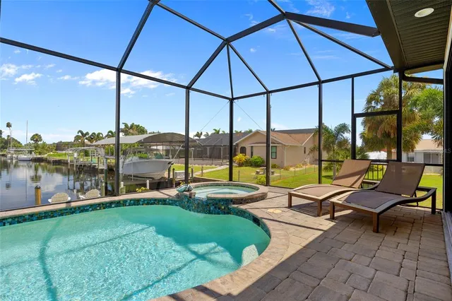 a view of a swimming pool with lawn chairs