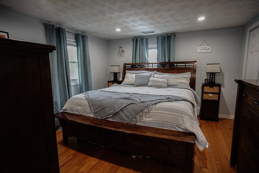 63 Wing Road Acushnet, MA 02743 - Photo 11 of 26 a bedroom with a bed and a black mirror