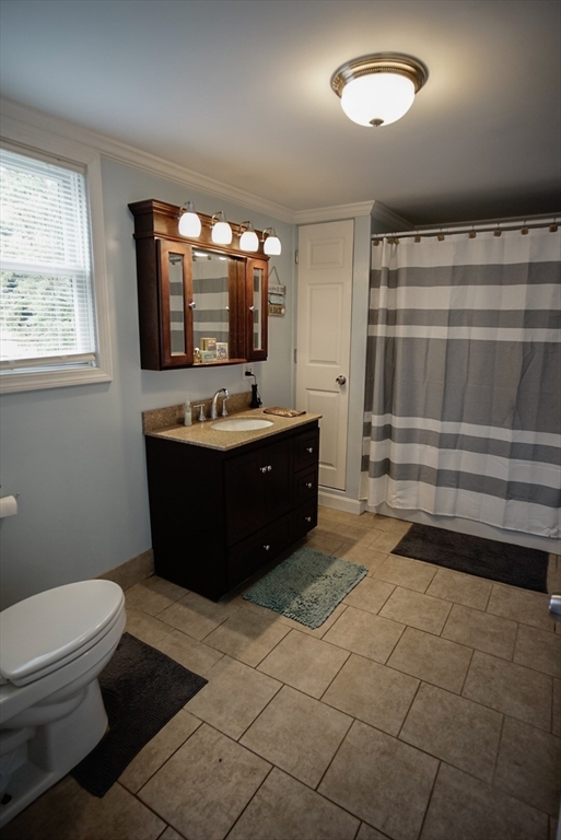 63 Wing Road Acushnet, MA 02743 - Photo 14 of 26 a room with a sink a mirror and a toilet