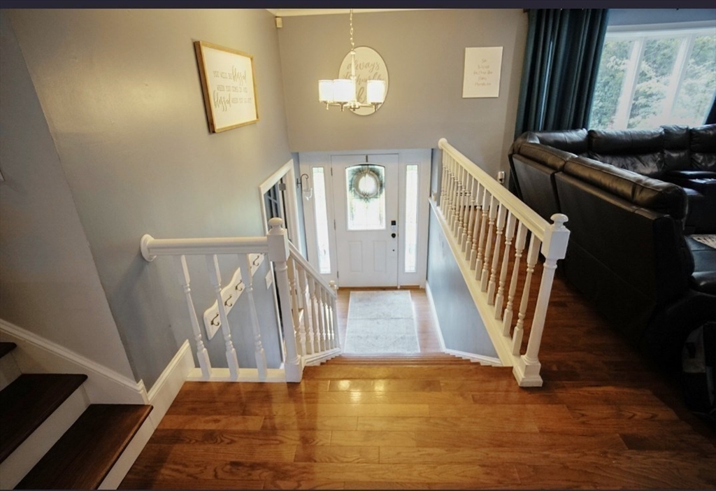63 Wing Road Acushnet, MA 02743 - Photo 3 of 26 a view of a livingroom with wooden floor and staircase