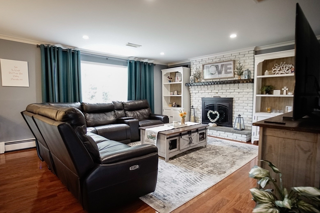 63 Wing Road Acushnet, MA 02743 - Photo 4 of 26 a living room with furniture and a fireplace