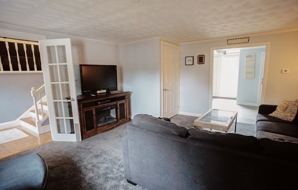 63 Wing Road Acushnet, MA 02743 - Photo 9 of 26 a living room with furniture and a flat screen tv