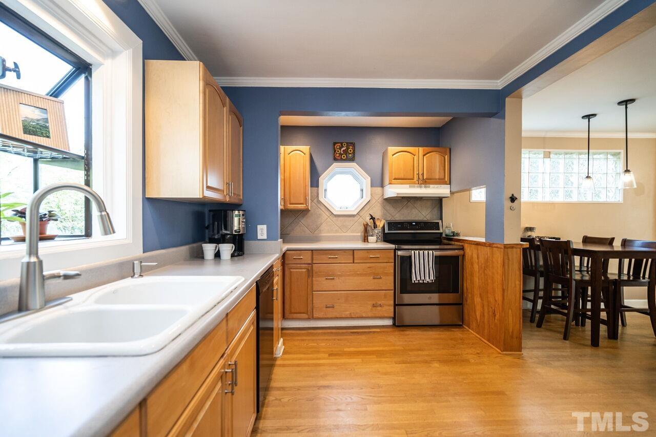 2715 Wayland Drive Raleigh, NC 27608 - Photo 8 of 30 a kitchen with a sink and a stove top oven