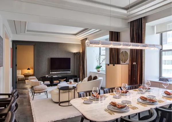a living room with furniture kitchen view and a flat screen tv