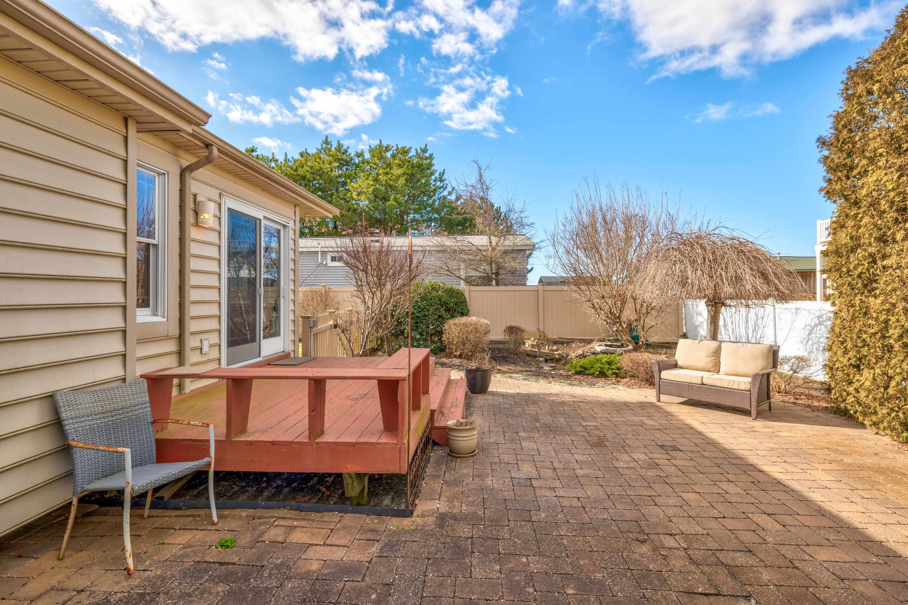 5 Adelphia Road Cape May, NJ 08204 - Photo 30 of 48 a view of a patio with a table and chairs and potted plants