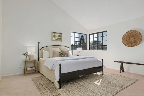 a large room with a bed and window