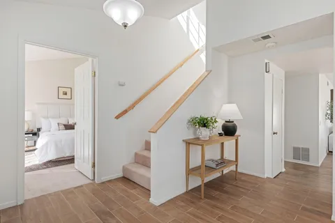 a view of entryway and hall with wooden floor