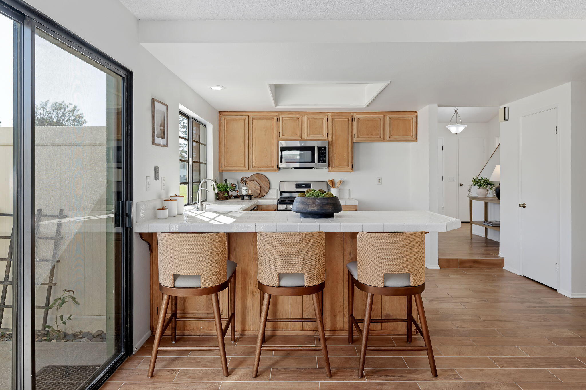 3426 Olds Road Oxnard, CA 93033 - Photo 10 of 30 a kitchen with stainless steel appliances granite countertop a table chairs refrigerator and cabinets