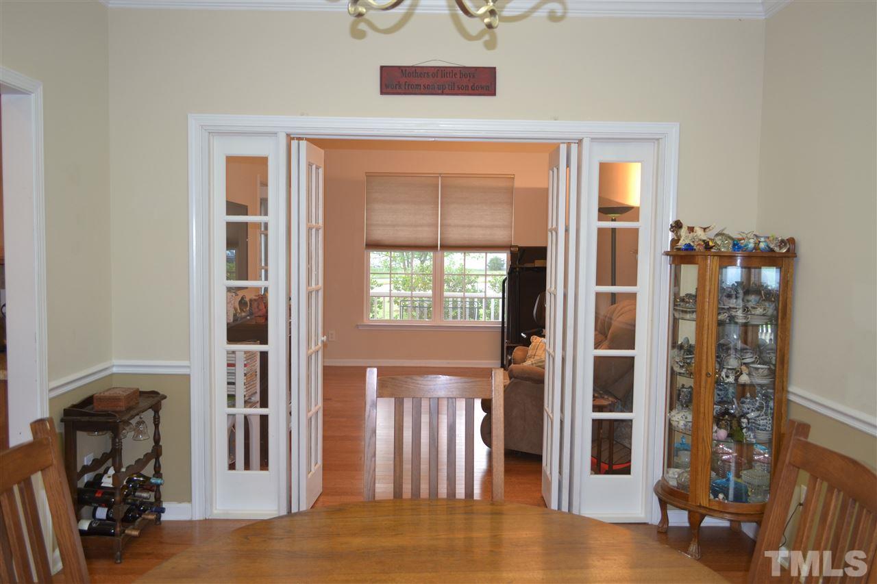 1421 Reynolds Mill Road Wake Forest, NC 27587 - Photo 7 of 18 Dining Room view into the Living Room area located on the front part of the home. Owner using this space as a game room/exercise area.