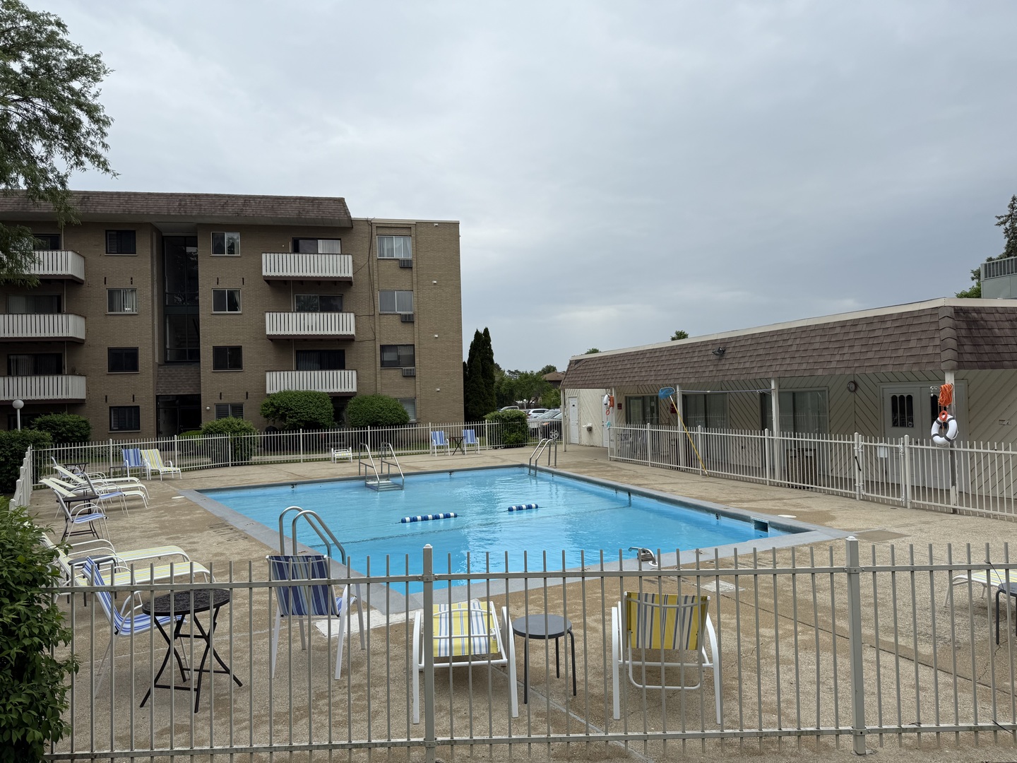290 North Westgate Road, Unit 401 Mount Prospect, IL 60056 - Photo 2 of 15 a view of a swimming pool with a lawn chairs