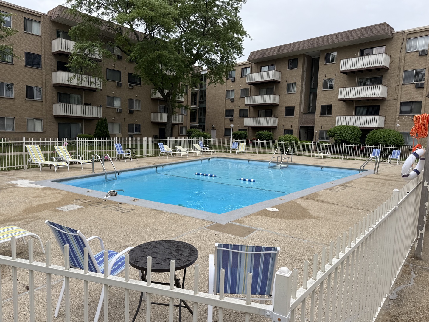 290 North Westgate Road, Unit 401 Mount Prospect, IL 60056 - Photo 3 of 15 a swimming pool with outdoor seating and yard