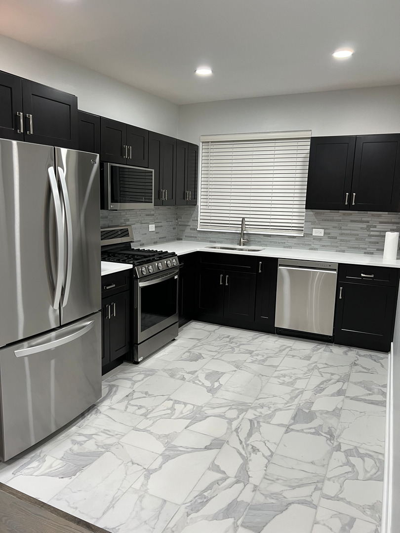 290 North Westgate Road, Unit 401 Mount Prospect, IL 60056 - Photo 6 of 15 a large kitchen with granite countertop a stove sink and refrigerator