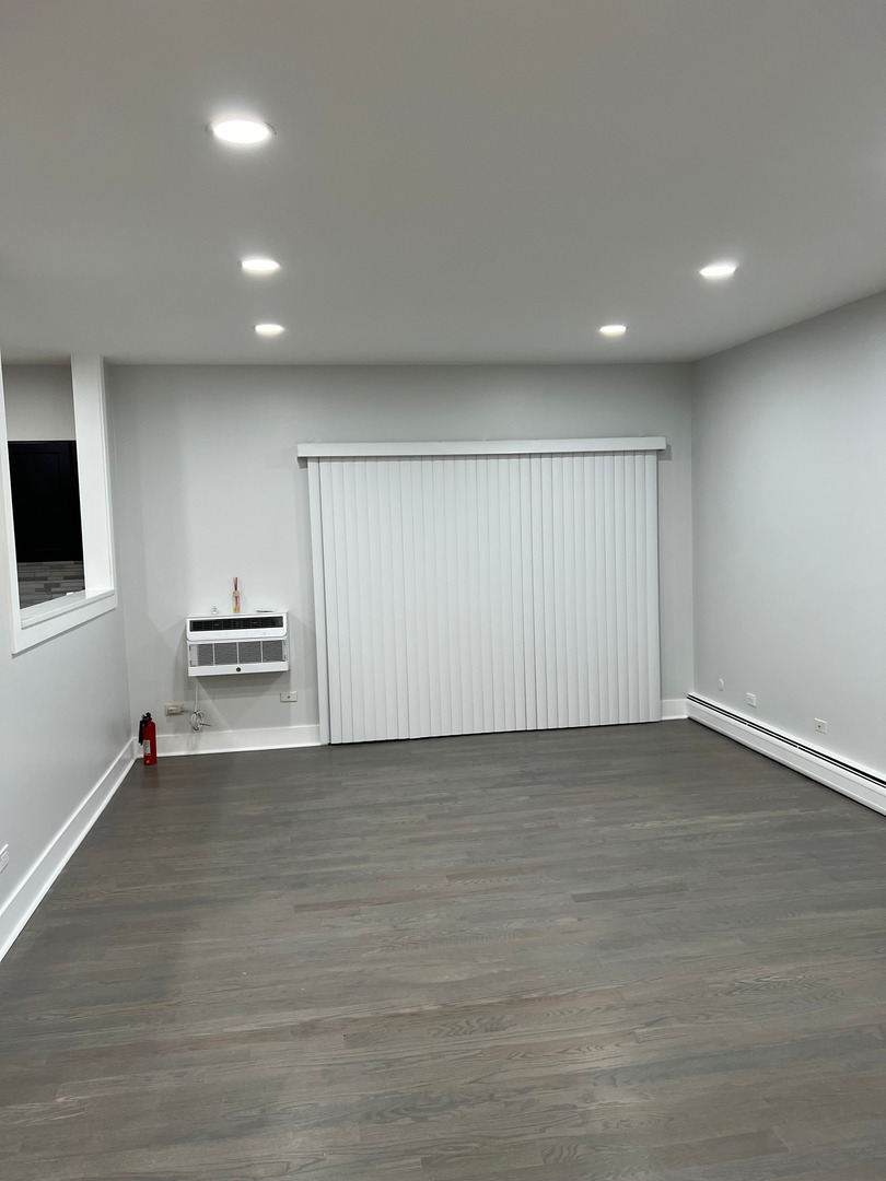 290 North Westgate Road, Unit 401 Mount Prospect, IL 60056 - Photo 7 of 15 an empty room with wooden floor and windows