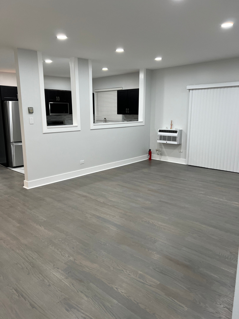 290 North Westgate Road, Unit 401 Mount Prospect, IL 60056 - Photo 8 of 15 an empty room with wooden floor and windows