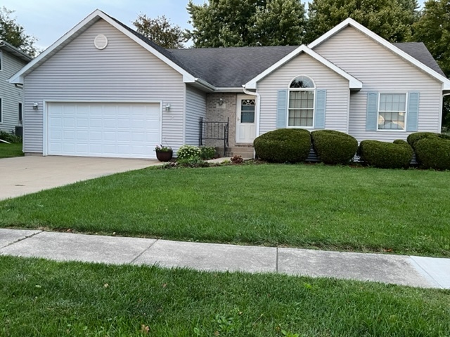 1121 McCall Court Rochelle, IL 61068 - Photo 2 of 41 a front view of a house with a yard and garage