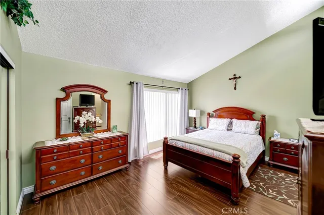 a bedroom with a bed and a dresser