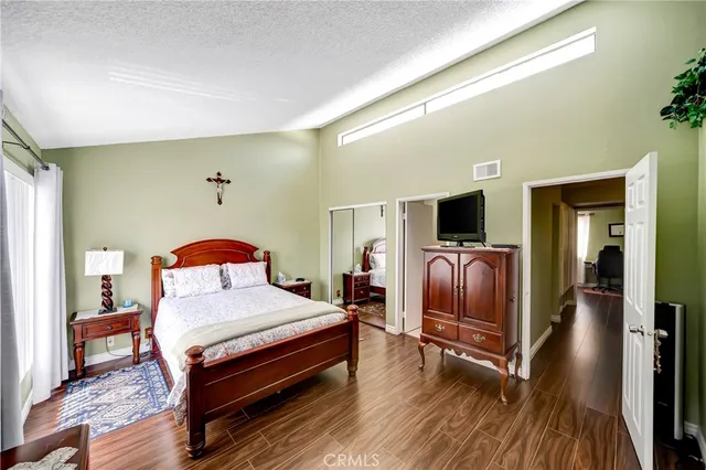 a bedroom with furniture and a flat screen tv