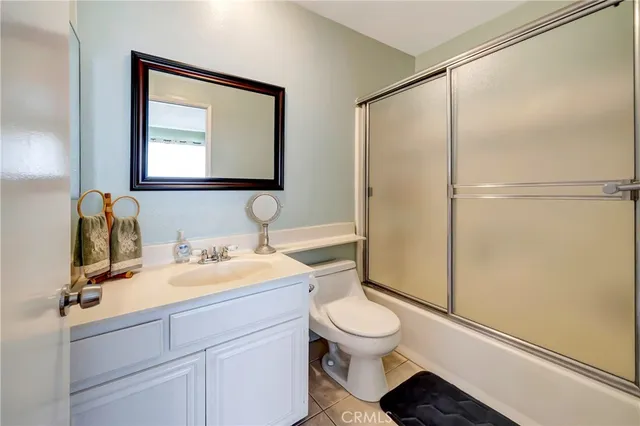 a bathroom with a toilet a sink and a mirror