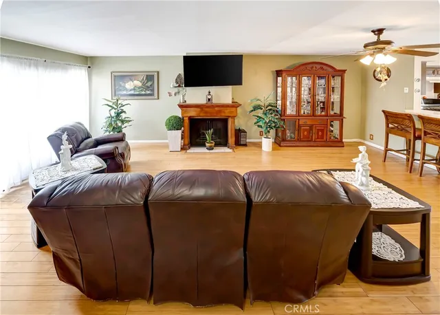 a living room with furniture a flat screen tv and a fireplace