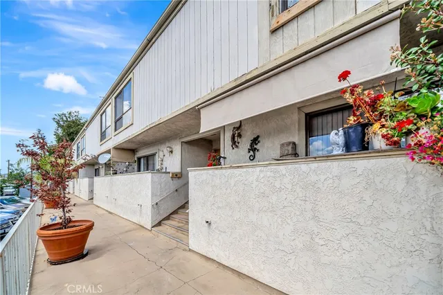 a front view of a house with plants