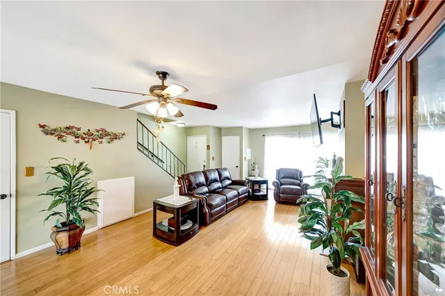 a living room with furniture potted plant and a chandelier