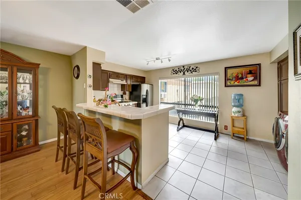 a kitchen with a sink cabinets and wooden floor