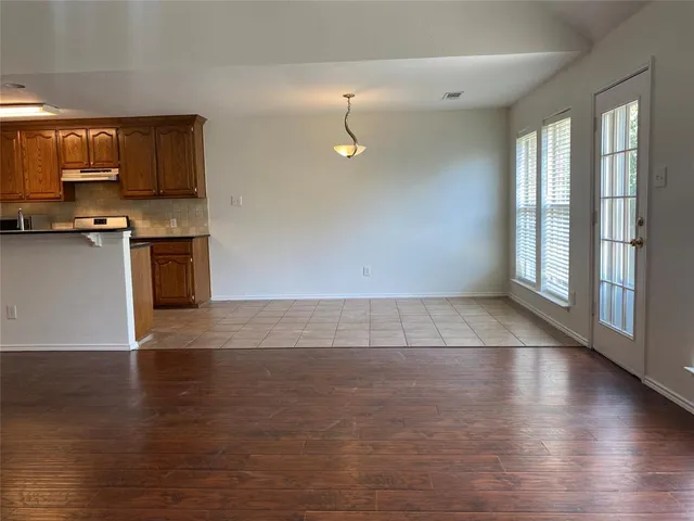 a view of a kitchen with stove and cabinets