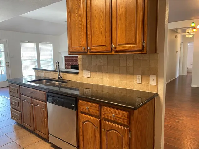 a kitchen with stainless steel appliances granite countertop a sink a stove and a microwave