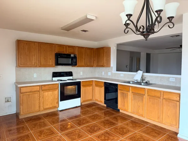 a kitchen with stainless steel appliances granite countertop a sink cabinets and a counter top space