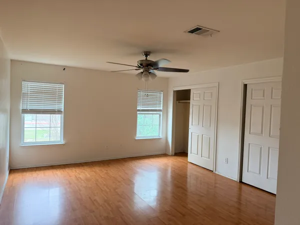 a view of a room window and wooden floor