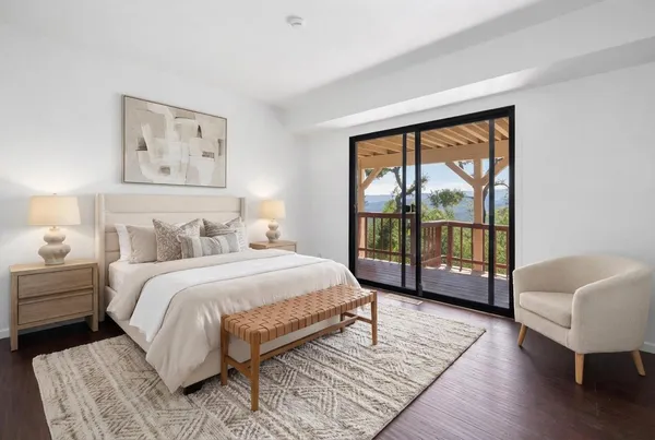 a spacious bedroom with a large bed and a large window