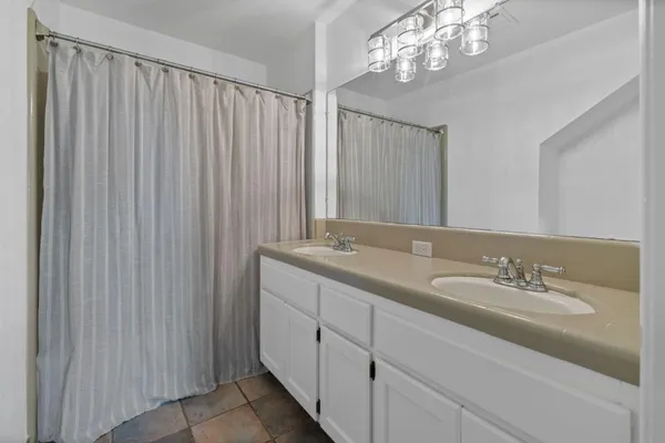 a bathroom with a double vanity sink and a mirror