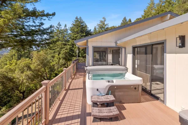 a view of a balcony with two chairs and a fire pit