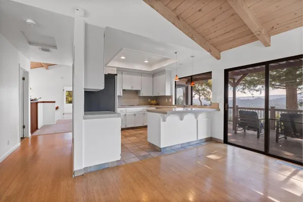 a open kitchen with cabinets and wooden floor
