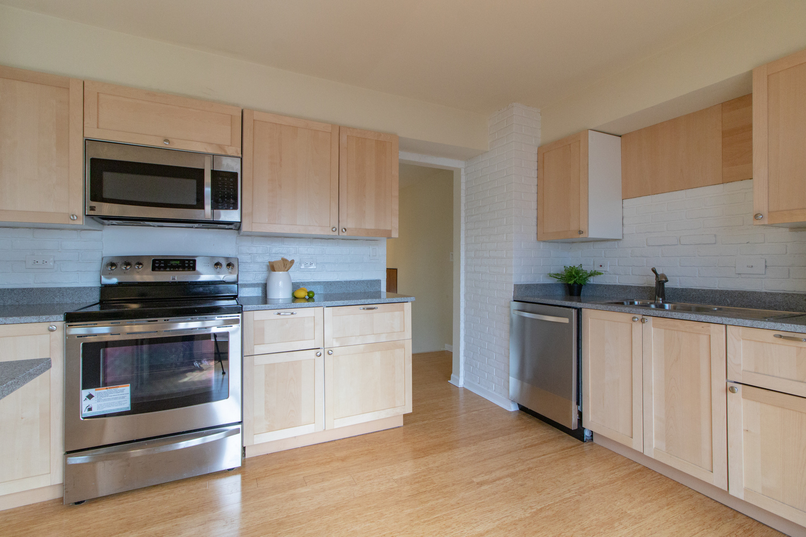 825 Freeman Road Hoffman Estates, IL 60192 - Photo 12 of 30 a kitchen with stainless steel appliances white cabinets and a stove top oven