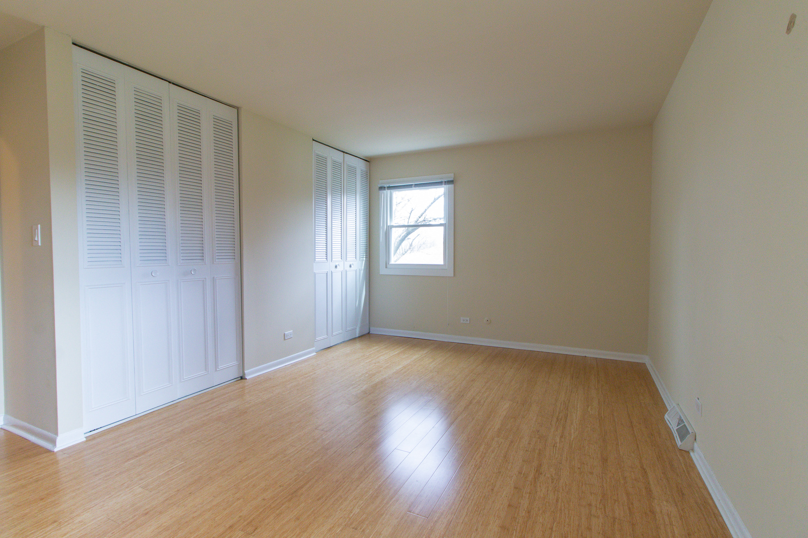 825 Freeman Road Hoffman Estates, IL 60192 - Photo 13 of 30 an empty room with wooden floor and windows