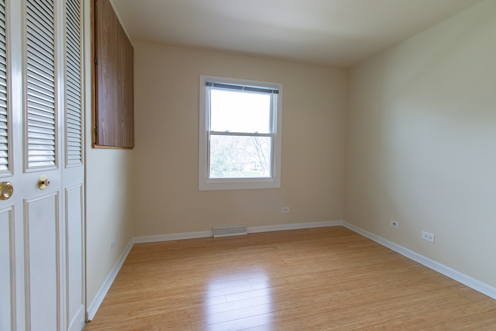 825 Freeman Road Hoffman Estates, IL 60192 - Photo 16 of 30 an empty room with wooden floor and windows