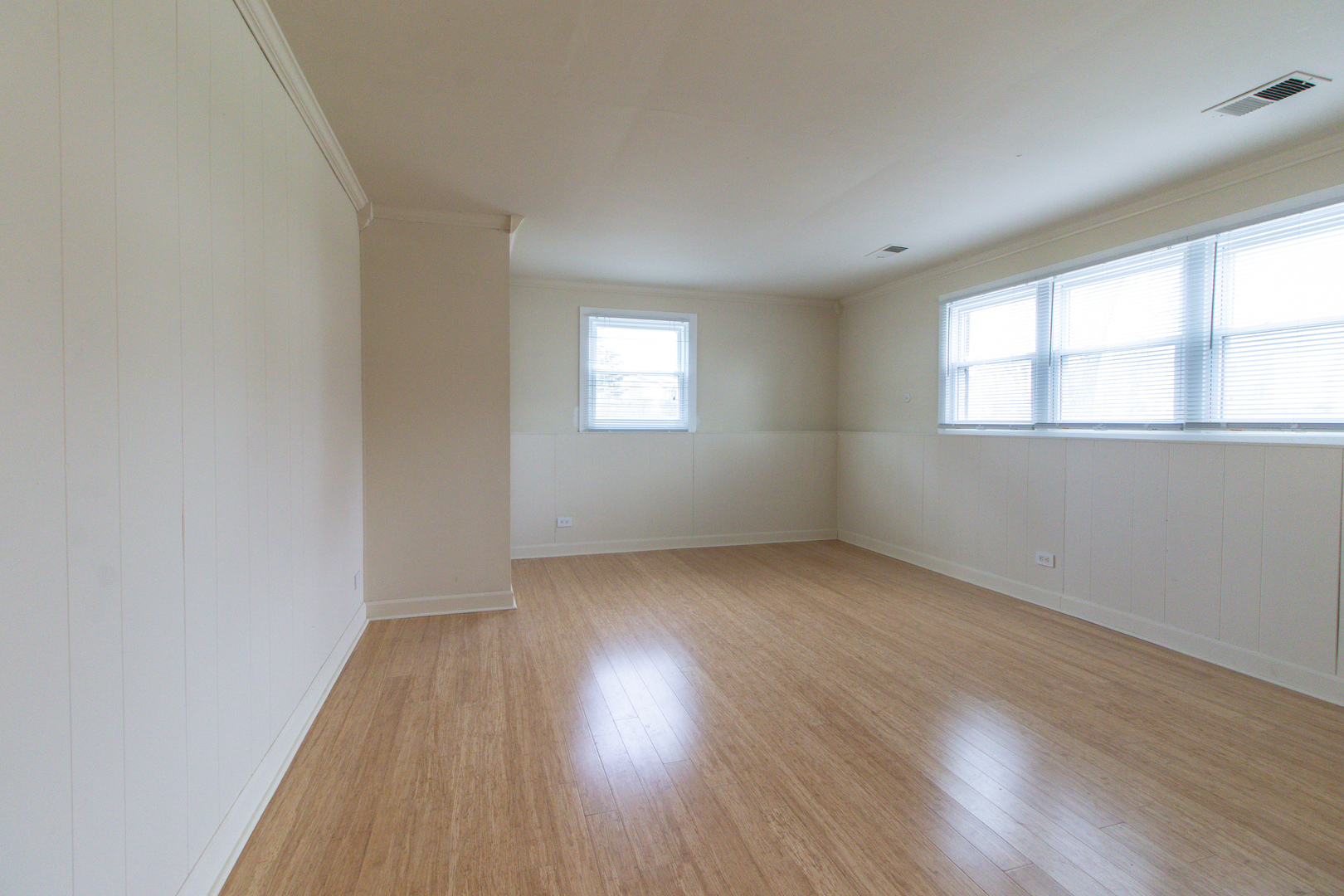 825 Freeman Road Hoffman Estates, IL 60192 - Photo 18 of 30 an empty room with wooden floor and windows