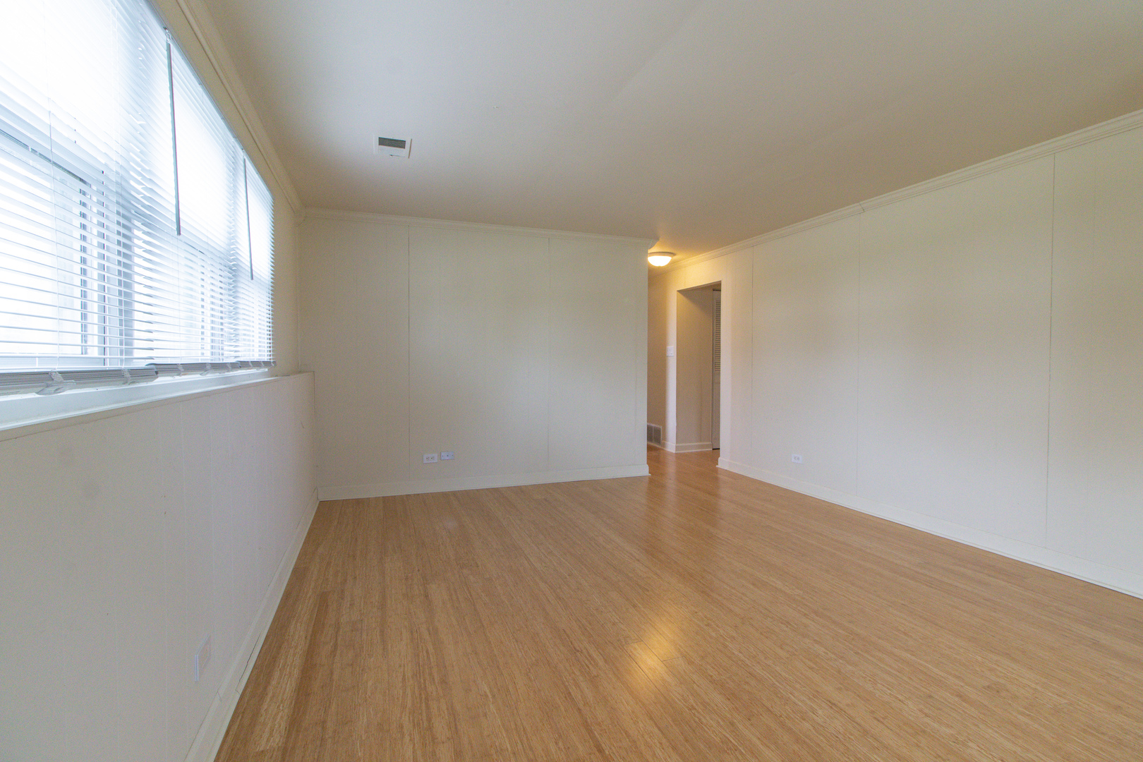 825 Freeman Road Hoffman Estates, IL 60192 - Photo 19 of 30 an empty room with wooden floor and windows