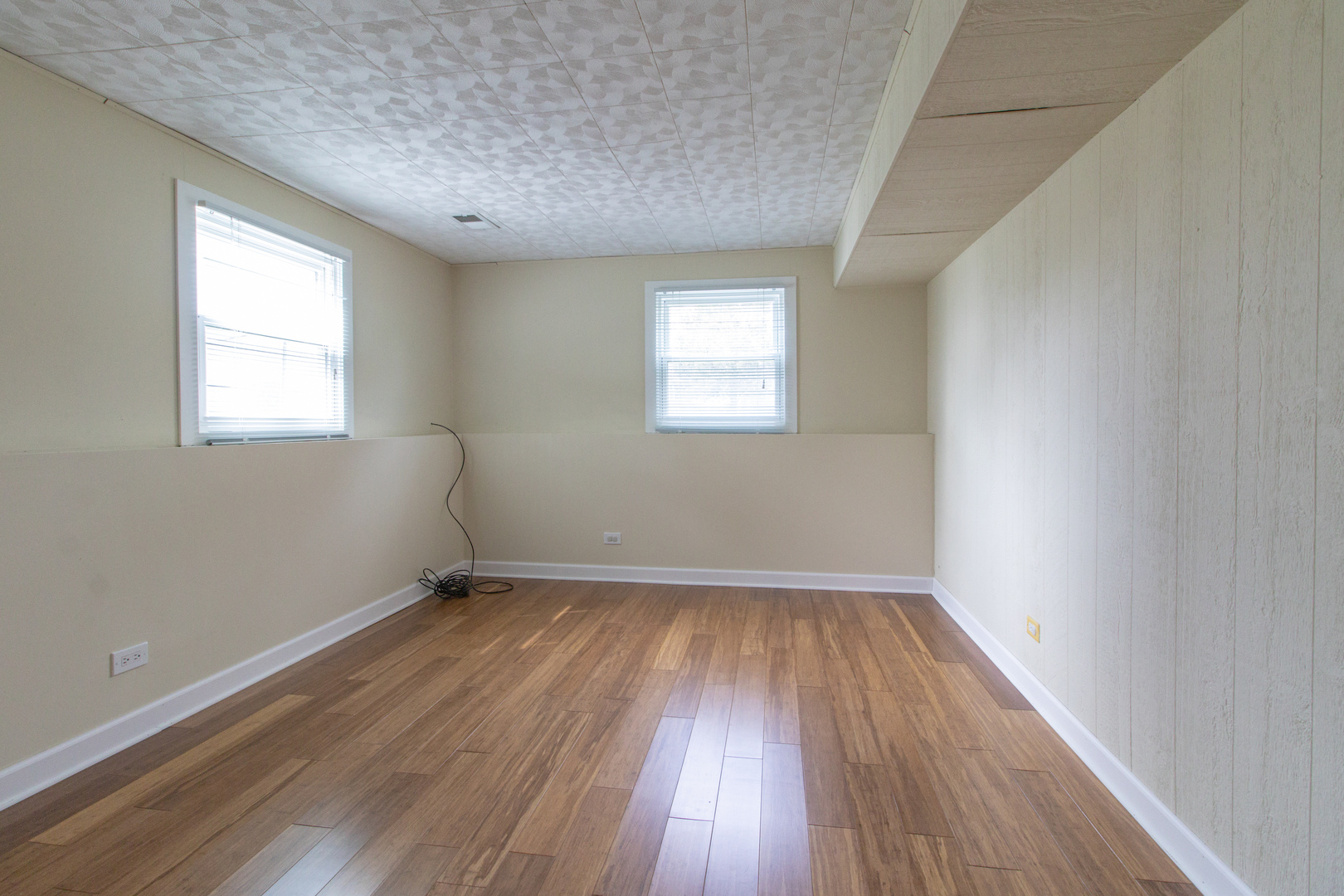 825 Freeman Road Hoffman Estates, IL 60192 - Photo 20 of 30 an empty room with wooden floor and windows
