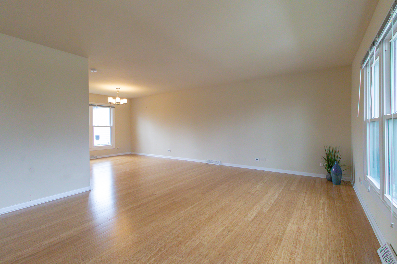 825 Freeman Road Hoffman Estates, IL 60192 - Photo 5 of 30 wooden floor in an empty room with a window