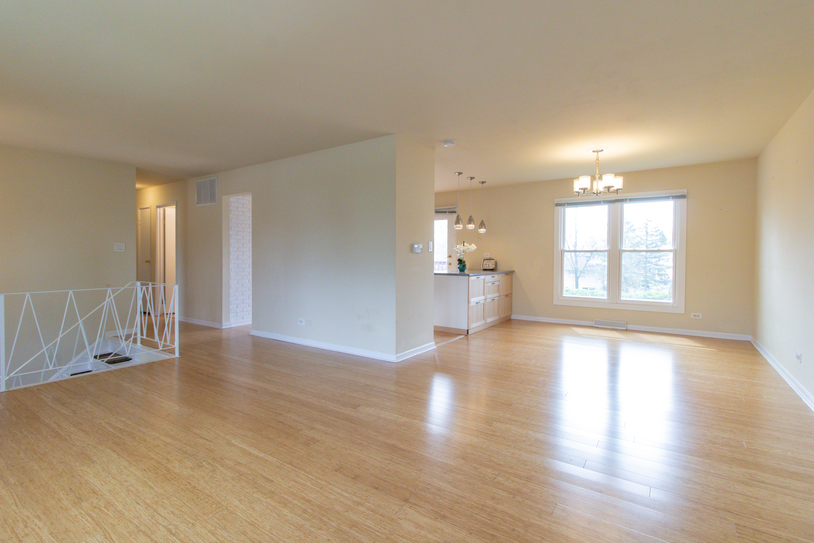 825 Freeman Road Hoffman Estates, IL 60192 - Photo 6 of 30 a view of an empty room with a window and wooden floor