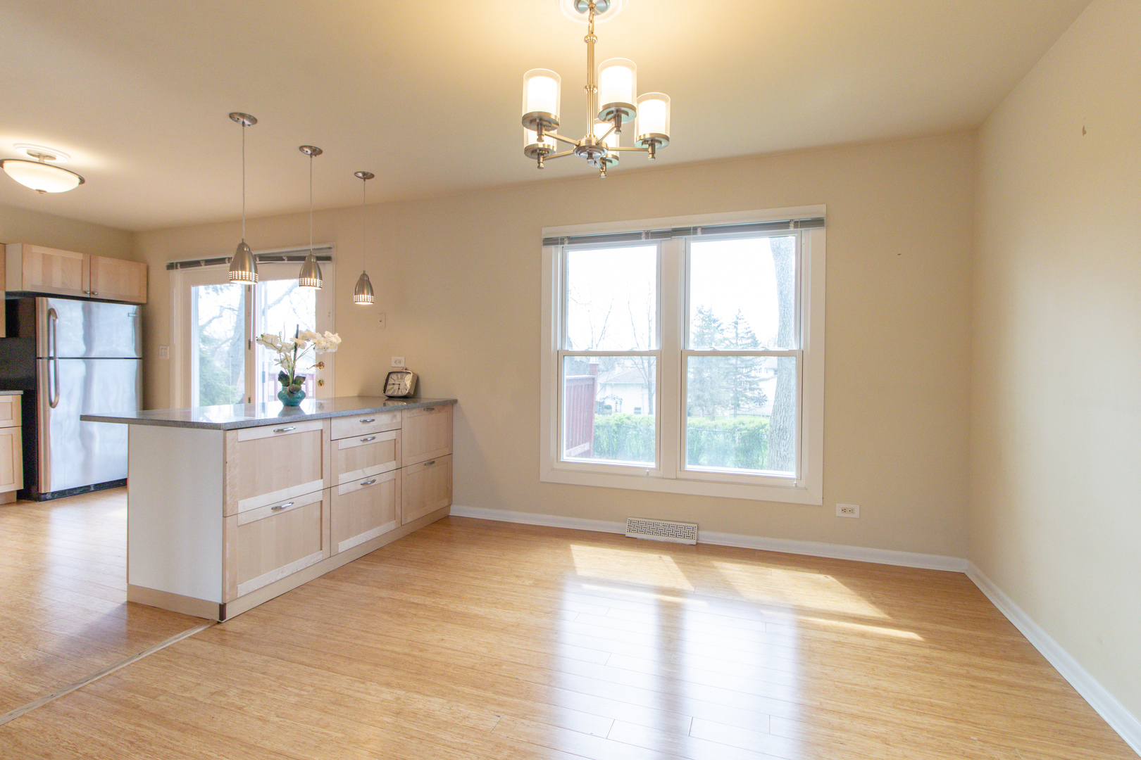 825 Freeman Road Hoffman Estates, IL 60192 - Photo 7 of 30 a view of a big room with windows and chandelier