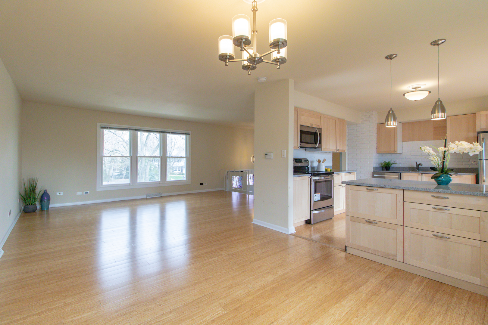 825 Freeman Road Hoffman Estates, IL 60192 - Photo 8 of 30 a kitchen with stainless steel appliances granite countertop a refrigerator a sink dishwasher a stove and white cabinets with wooden floor