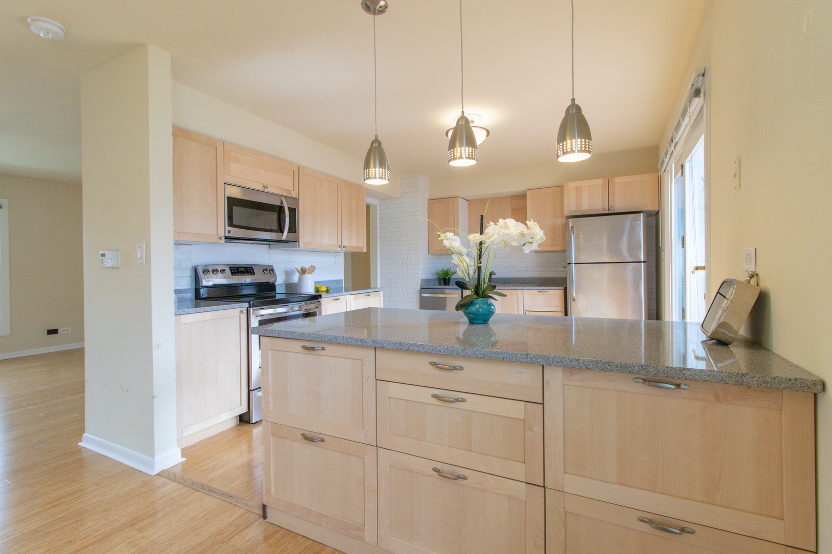 825 Freeman Road Hoffman Estates, IL 60192 - Photo 9 of 30 a kitchen with kitchen island granite countertop a stove a sink and a refrigerator