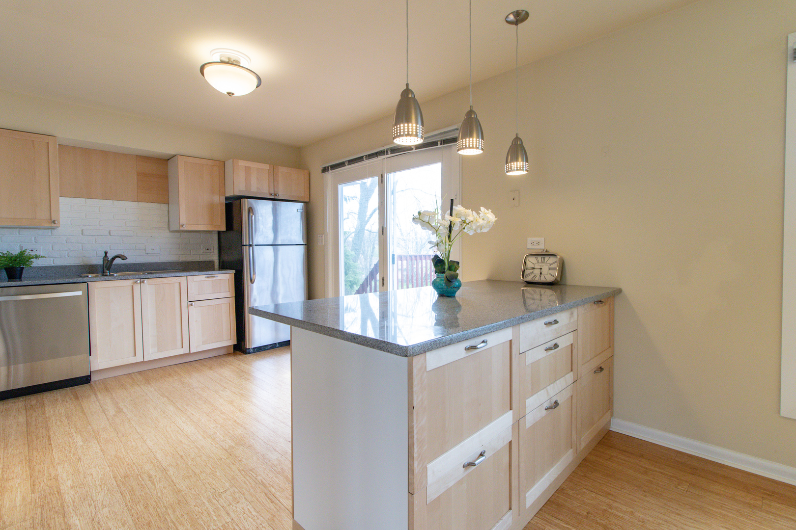 825 Freeman Road Hoffman Estates, IL 60192 - Photo 10 of 30 a kitchen with granite countertop a sink and cabinets