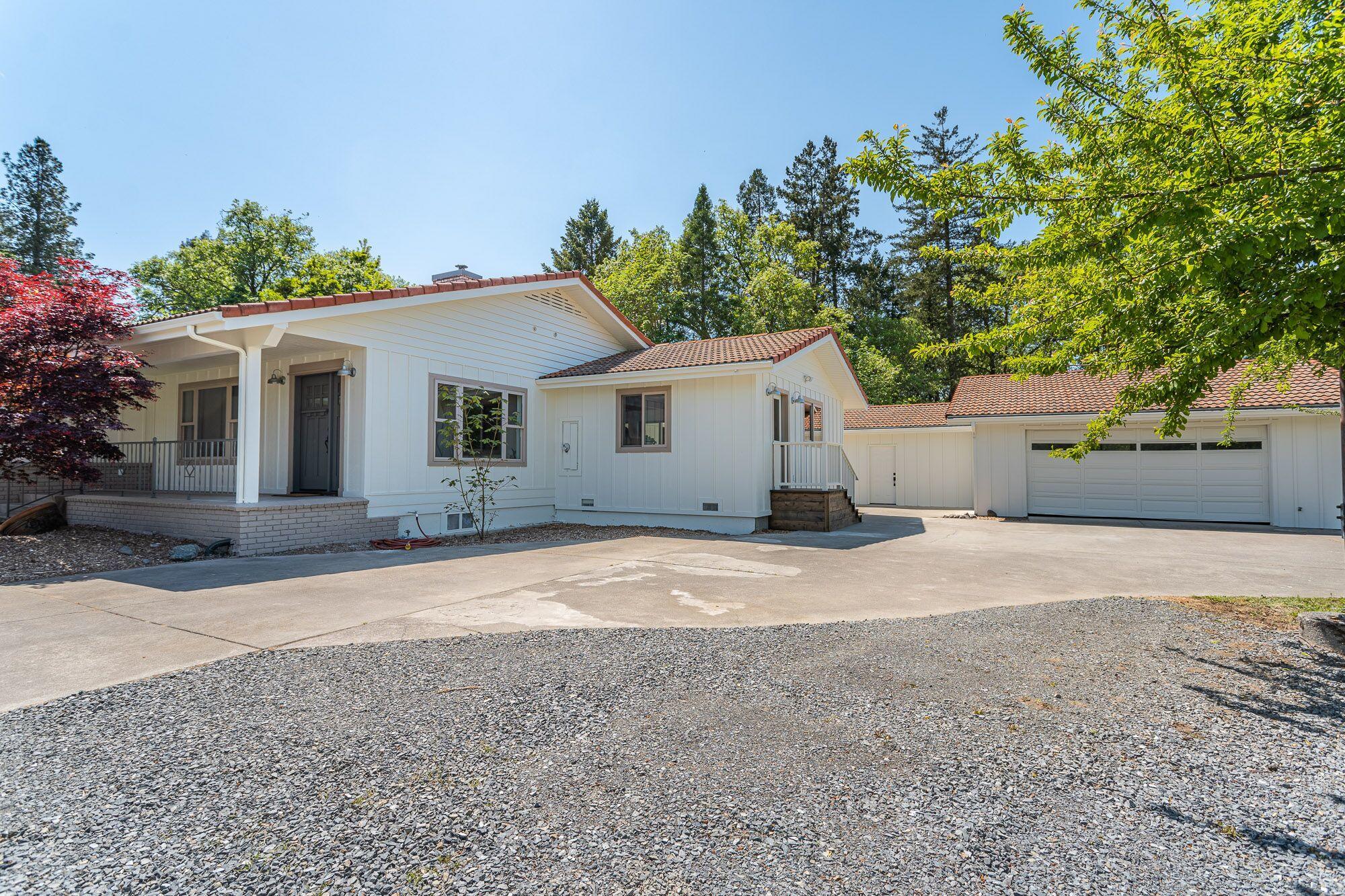 3134 South River Road Grants Pass, OR 97527 - Photo 33 of 38 a view of a house with a yard and garage