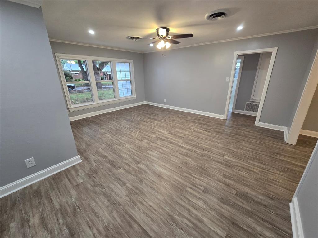 233 Roma Drive Shreveport, LA 71105 - Photo 6 of 12 Spare room with crown molding, ceiling fan, dark wood finished floors, and recessed lighting
